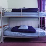 Our bunk beds with our warm comforters and fluffy pillows.